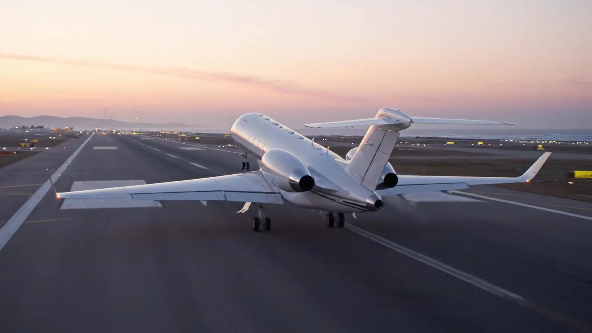 Business jet taking off at dawn
